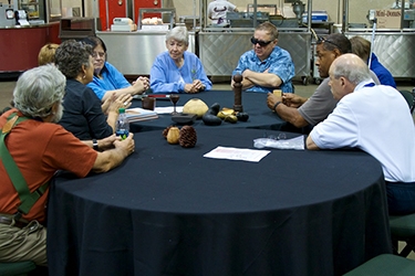 Betty Scarpino, Al Stirt and Malcolm Zander meeting with the group