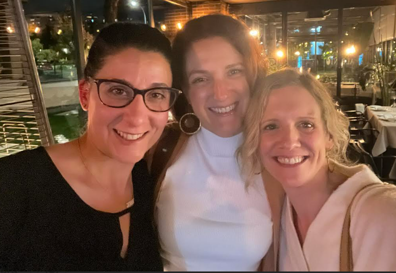 A group of women smiling for a selfieDescription automatically generated