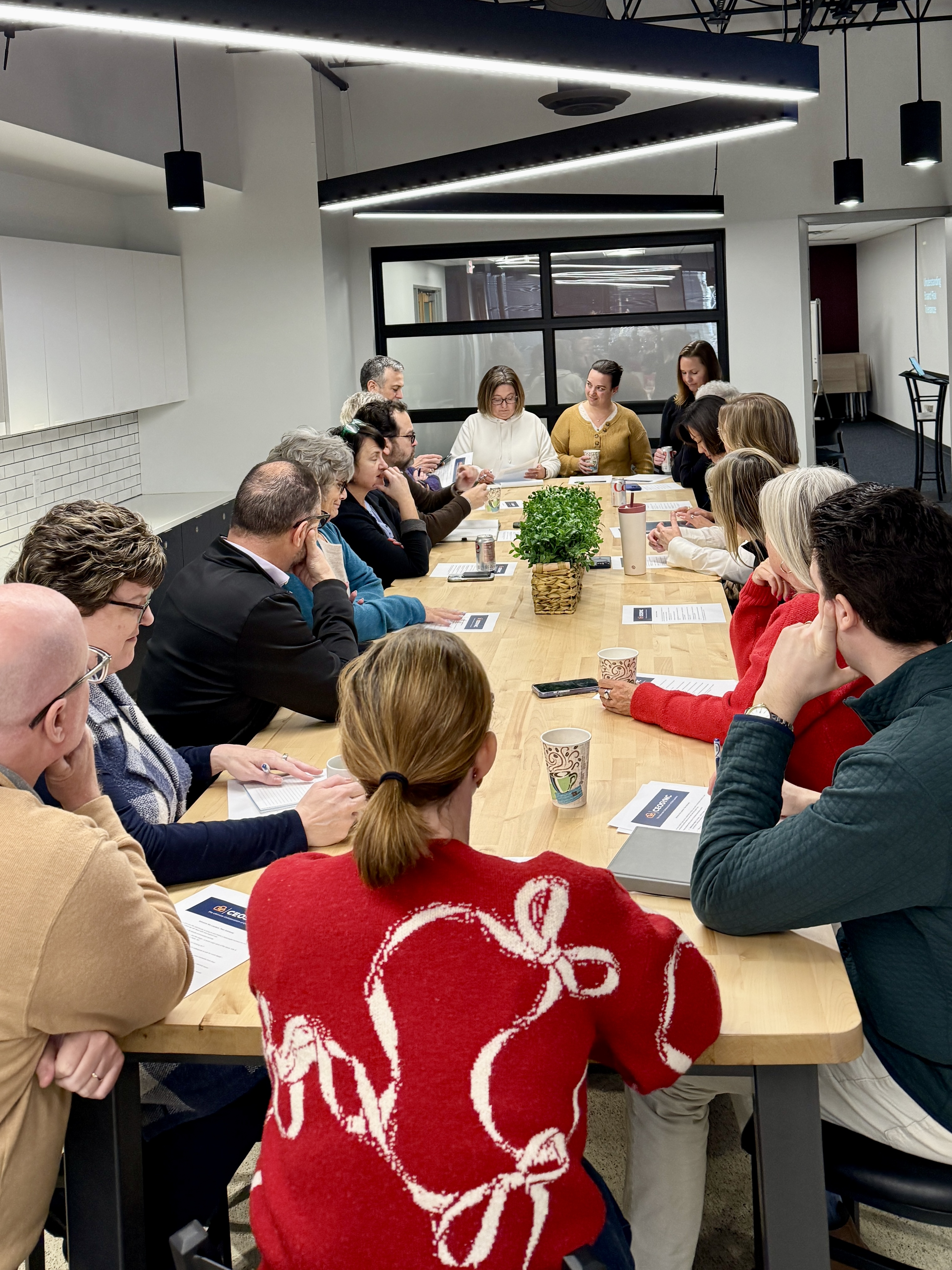 The CEOSync cohort gathered around a table