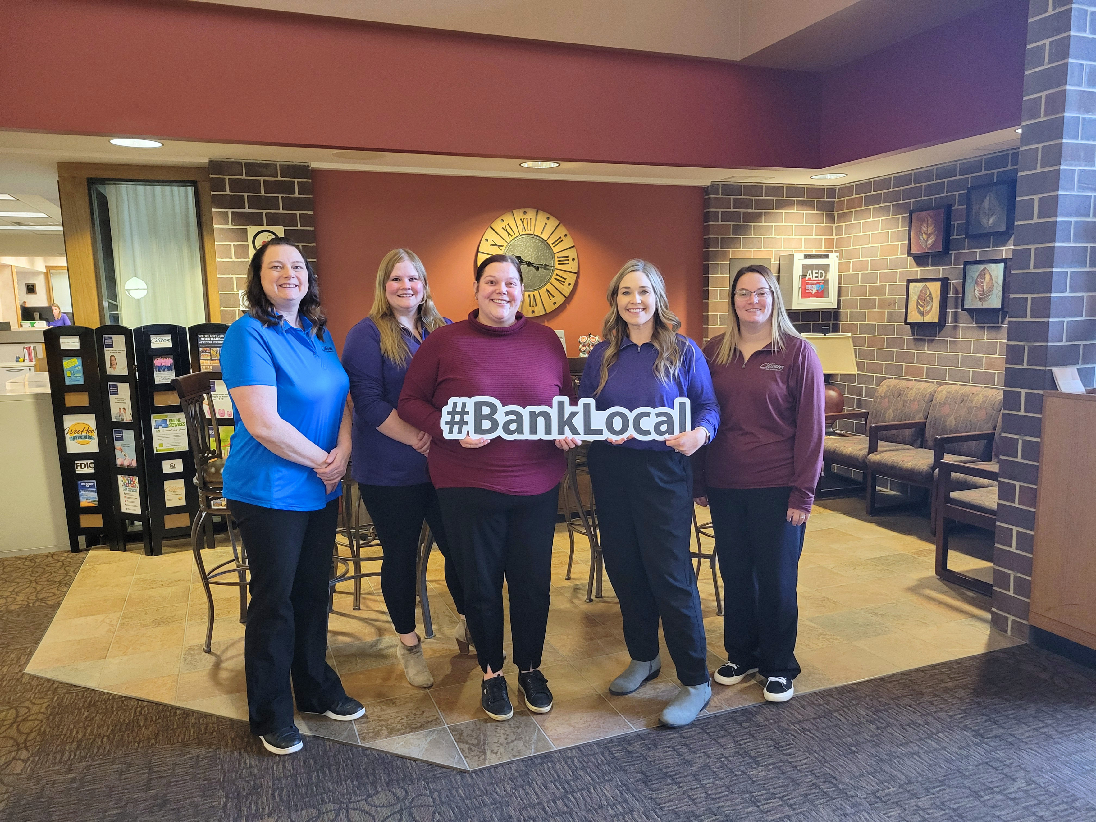 Five community bankers holding a #BankLocal sign