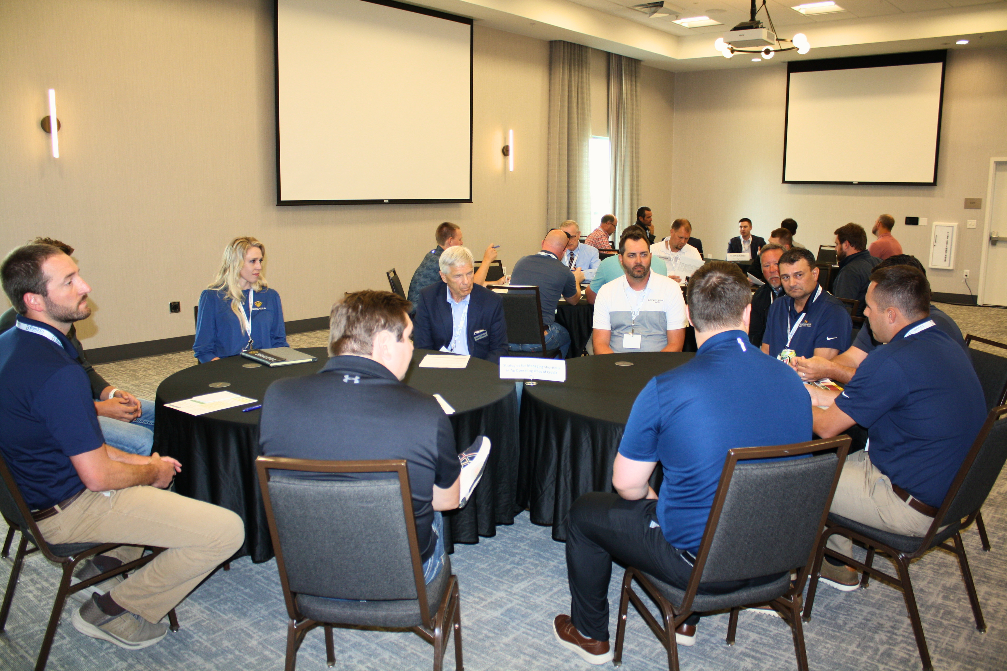 Ag Conference attendees exchange ideas during small-group roundtable discussions.