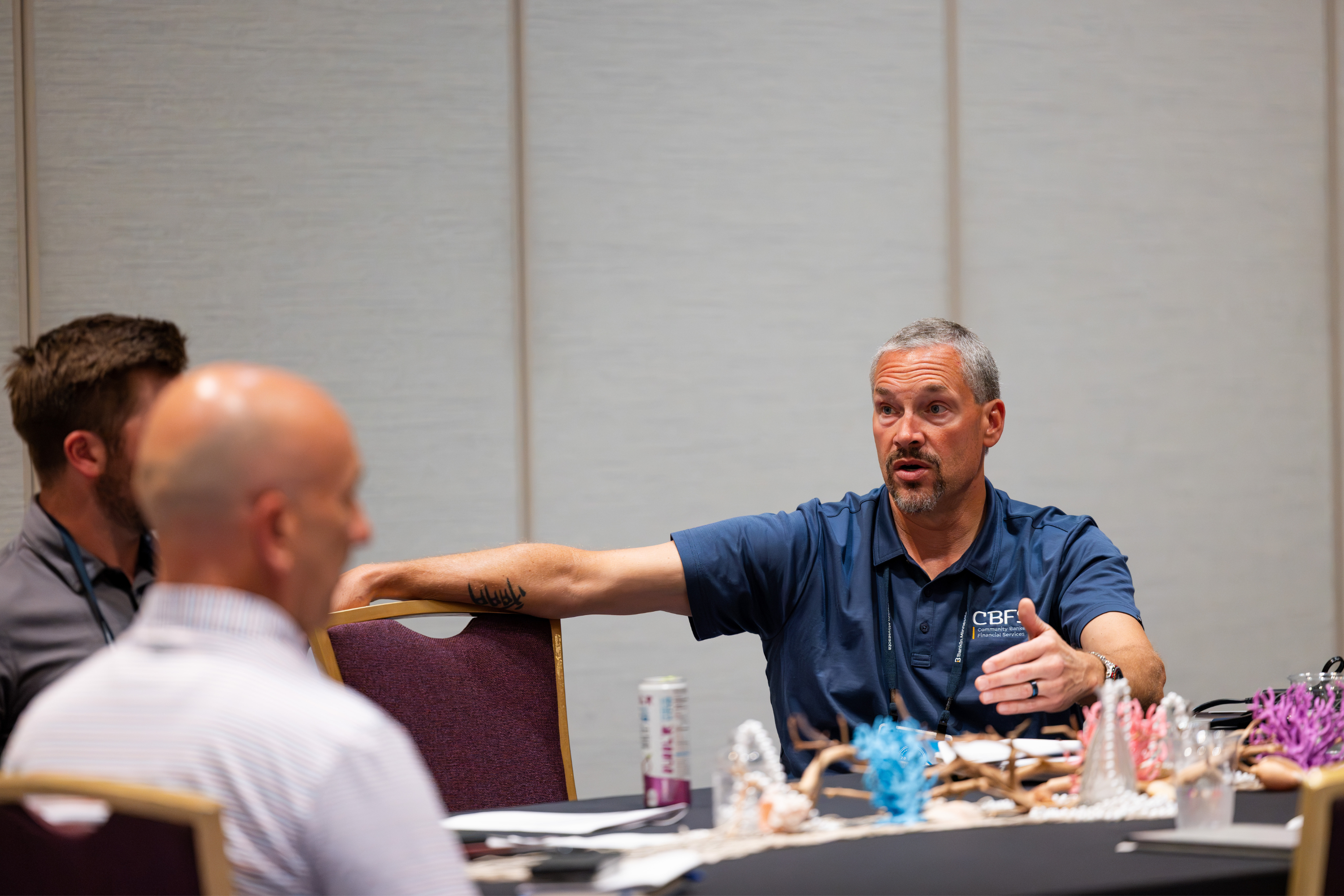 Curt Smallbrock discusses community banking needs with bankers at a BankIn Minnesota roundtable.