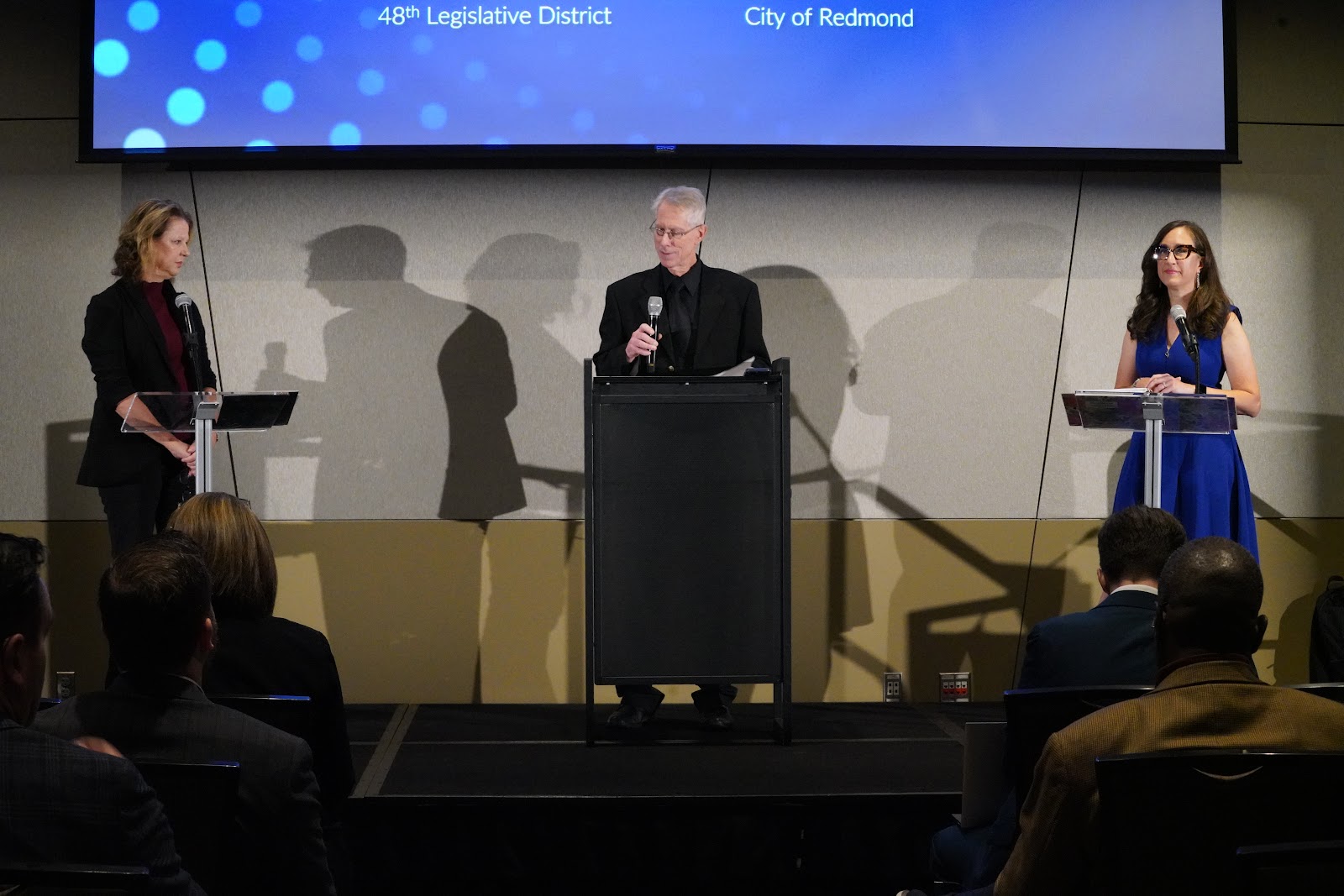 Rep. Amy Walen, moderator Jerry Cornfield and Redmond Councilmember Jessica Forsythe at the 48th District debate