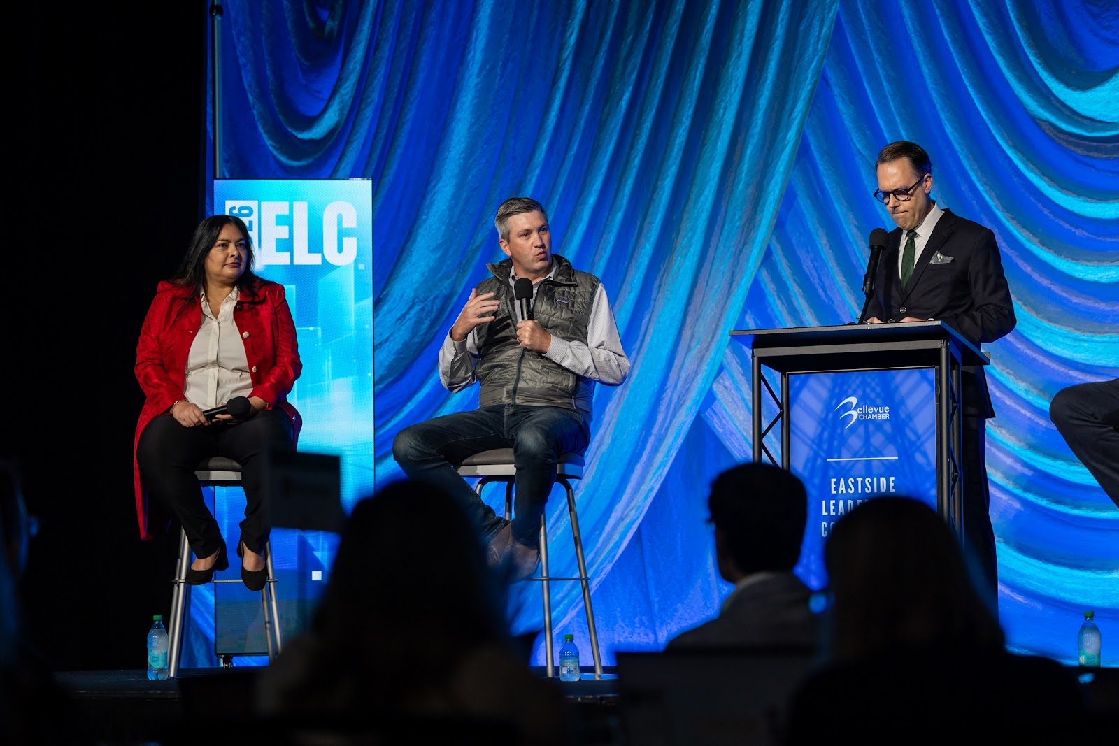 Sen. Manka Dhingra and a fellow panelist during Tax the Rich?, with KOMO's Chris Daniels at the podium