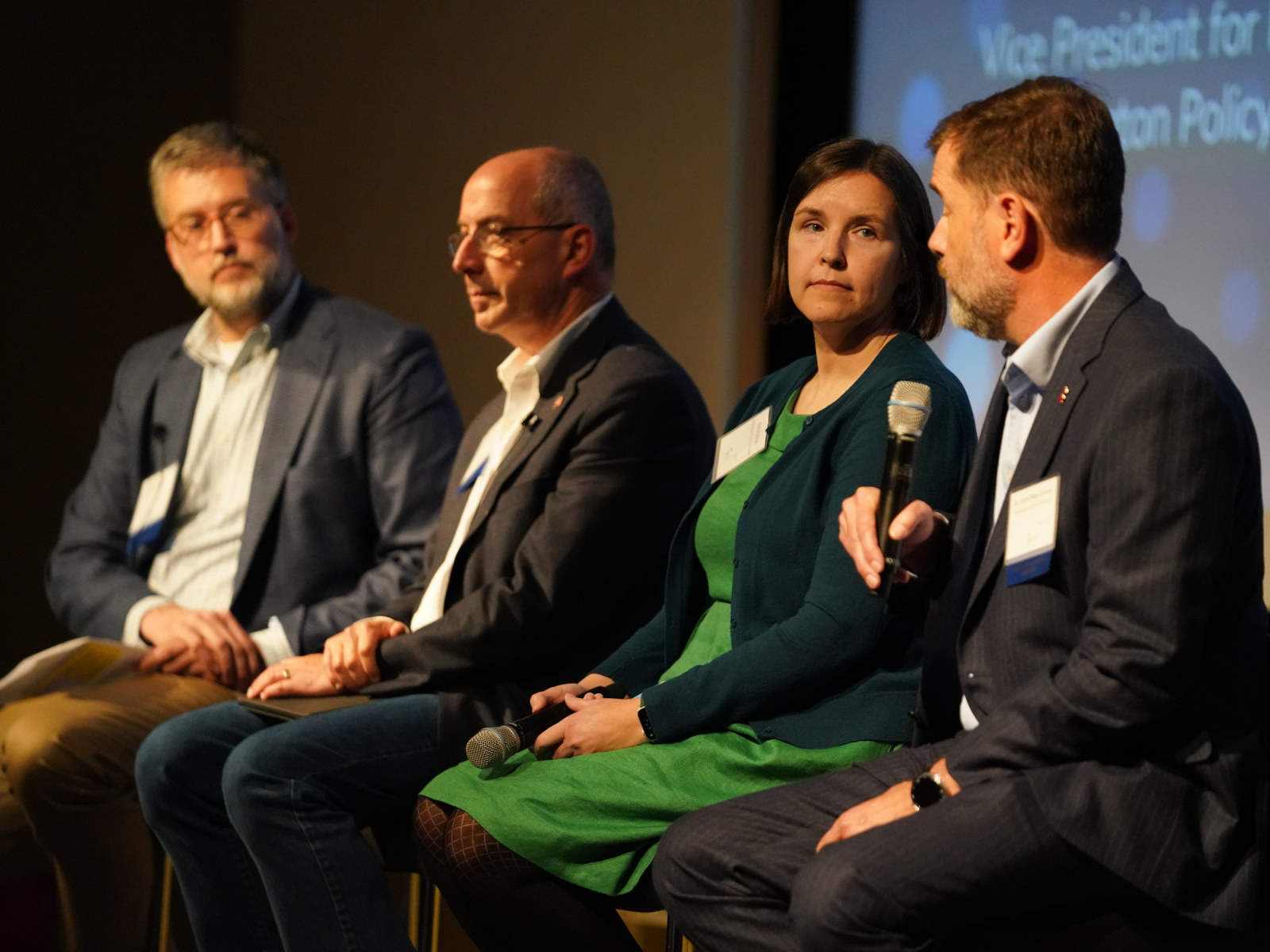 Executives speaking on stage at a signature event