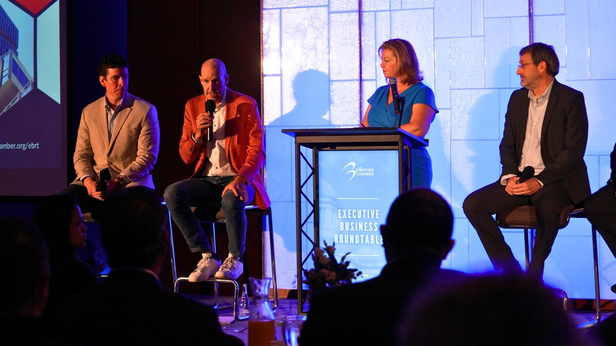 Panelists on stage at an Executive Business Roundtable