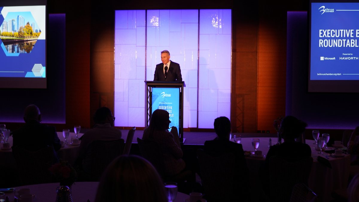 The Executive Business Roundtable stage with branded screens