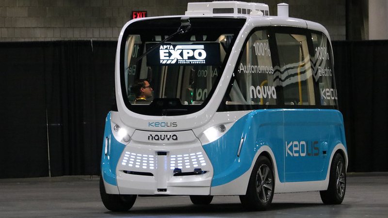 An autonomous electric shuttle on a show floor