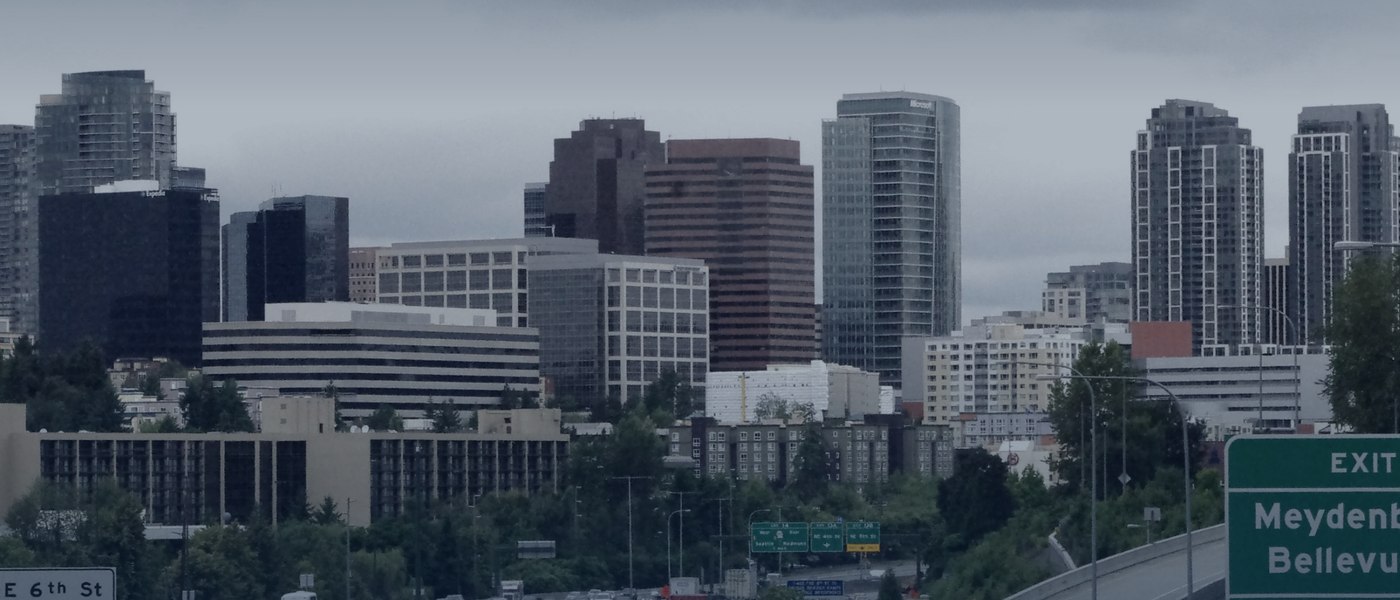 A growing downtown skyline with construction cranes and Mount Rainier