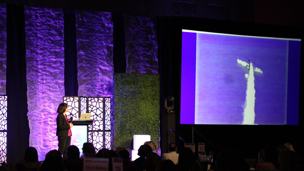 A rocket launch on screen at a Chamber program