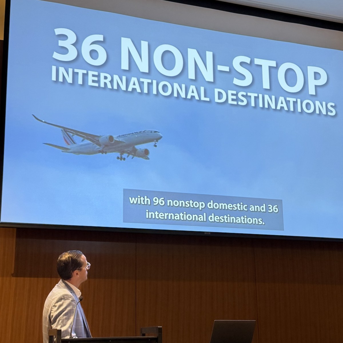 Chris Wimsatt presents a slide showing SEA&rsquo;s 96 domestic and 36 international nonstop destinations