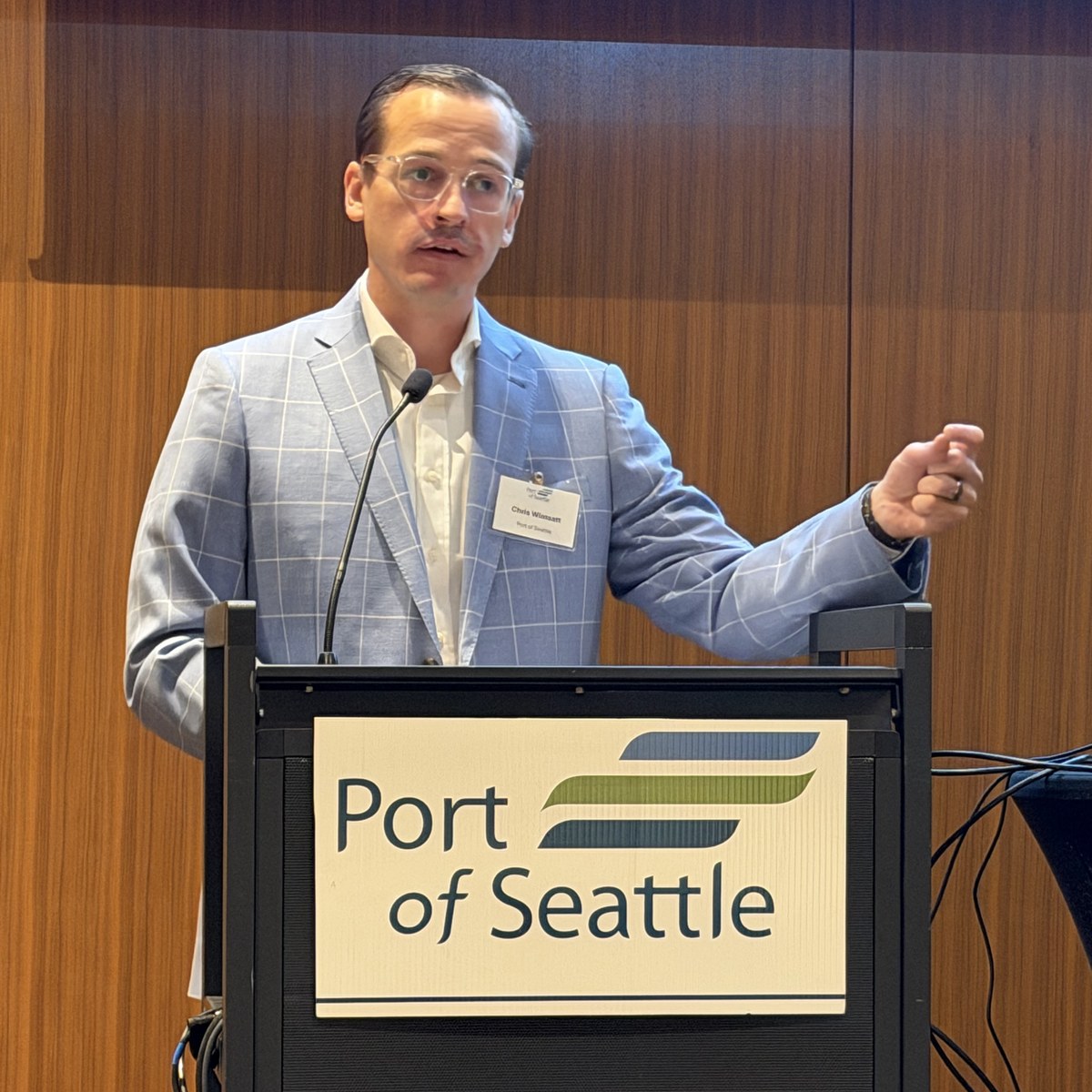 Port of Seattle CFO Chris Wimsatt speaking at the podium at Meydenbauer Center
