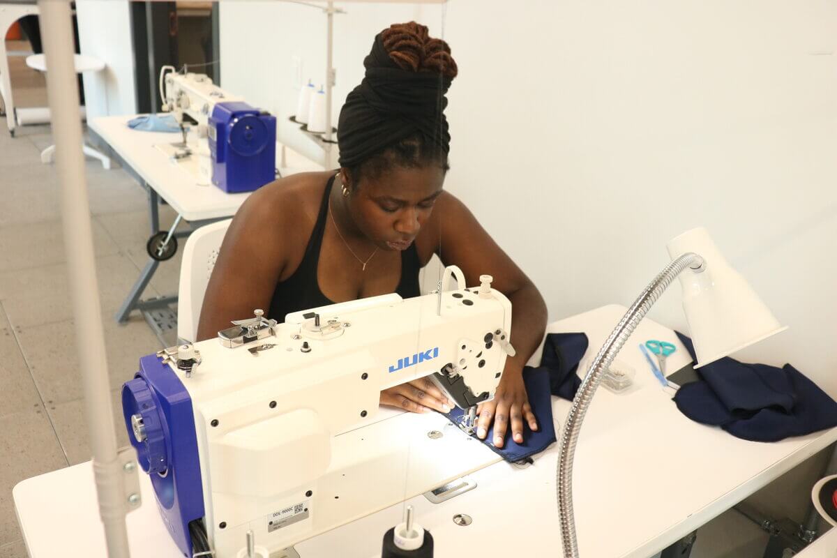 Production work on SparkDefy welding caps at an industrial sewing machine