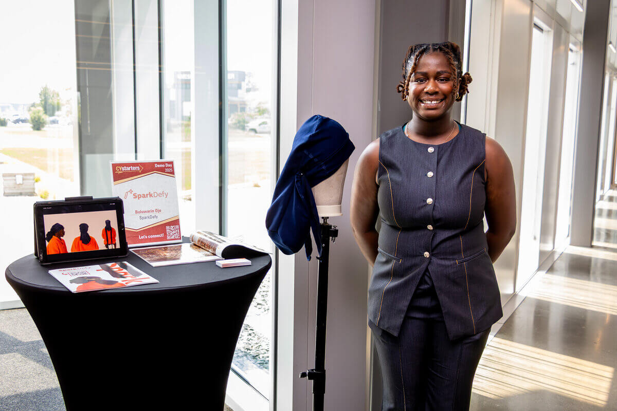 Bolu Ojo presenting SparkDefy at CYstarters Demo Day 2025 with her product on display