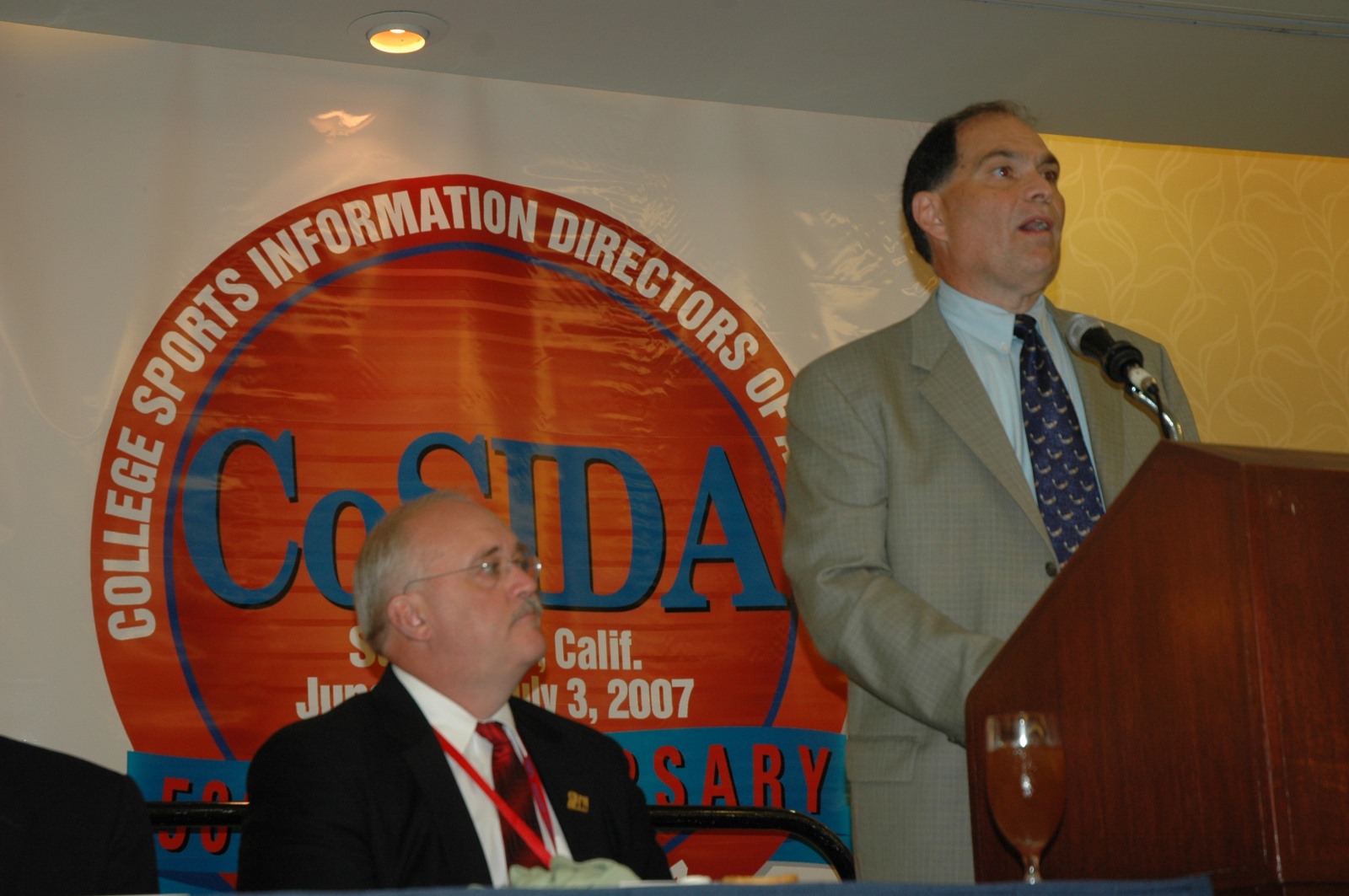 Arnie Sgalio speaking at the 2007 CSC Convention. Doug Dull is seated at left.