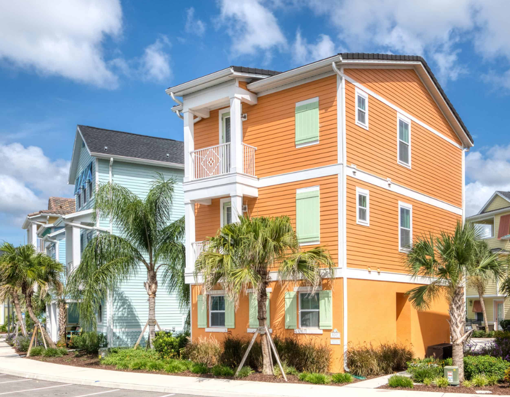 A row of houses with palm treesDescription automatically generated