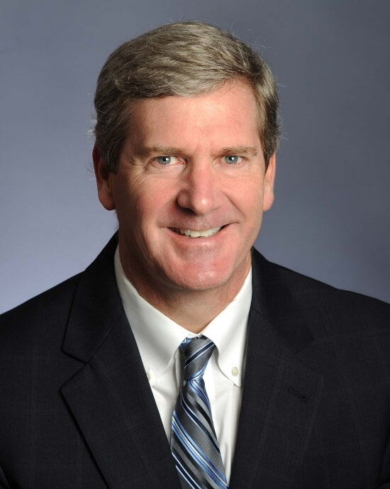 A person in a suit and tieDescription automatically generated