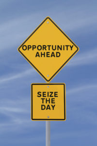 Yellow signs with the words "Opportunity Ahead" and "Seize the Day"