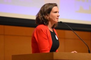 Jennifer Hutchins speaking at a podium