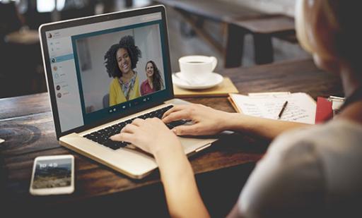 Image of a laptop with someone on screen on a videoconference call
