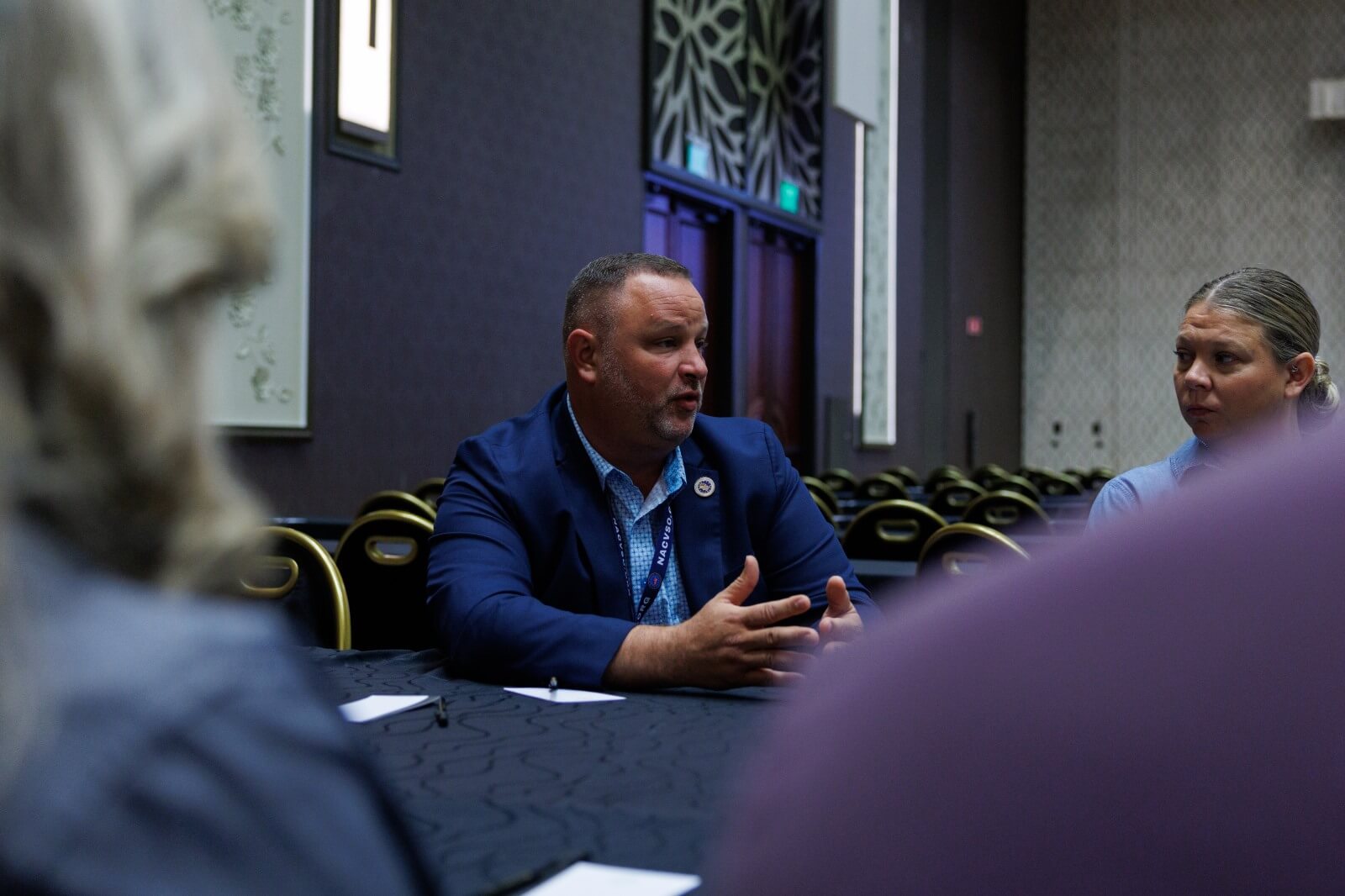 Mike Mortensen speaking with Deputy Secretary of Veteran Affairs (DEPSECVA), Paul R. Lawrence, Ph.D during the 2026 NACVSO Conference