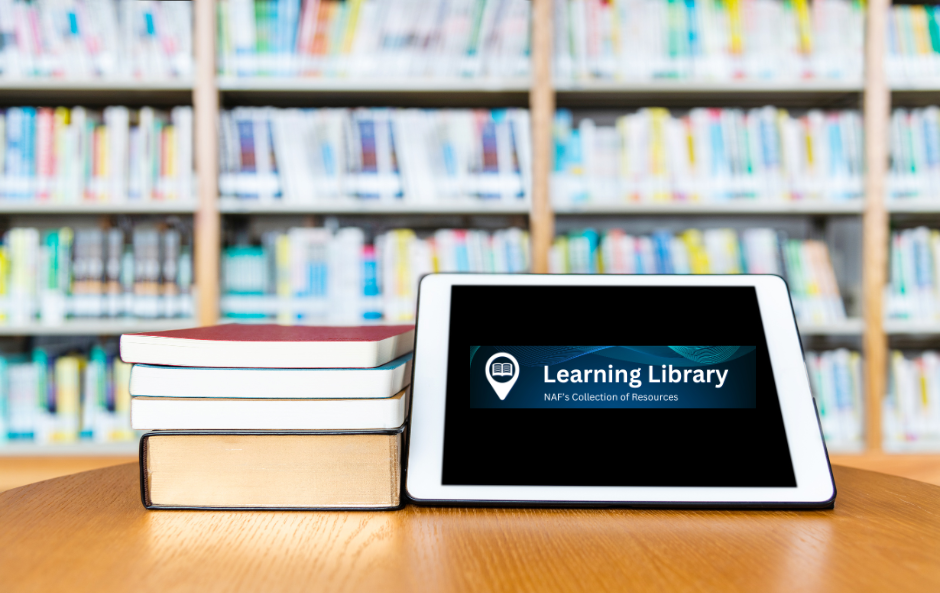A tablet and books on a tableDescription automatically generated