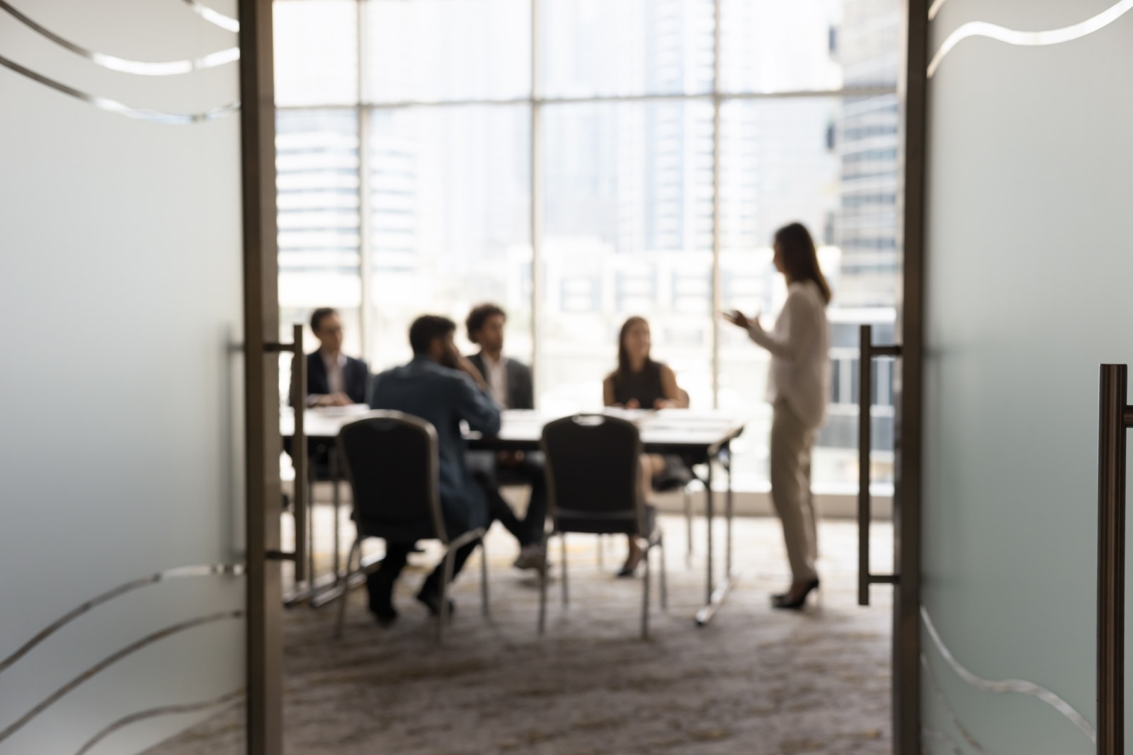 Blurred professionals sitting at a conference room table
