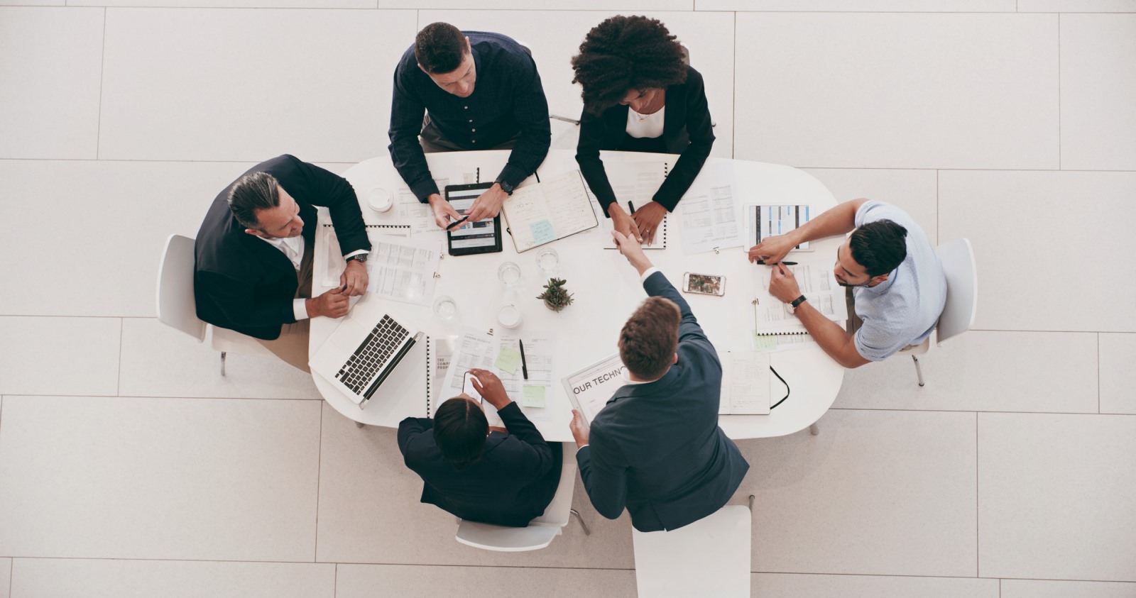 Overhead shots of professional sitting at a round conference table