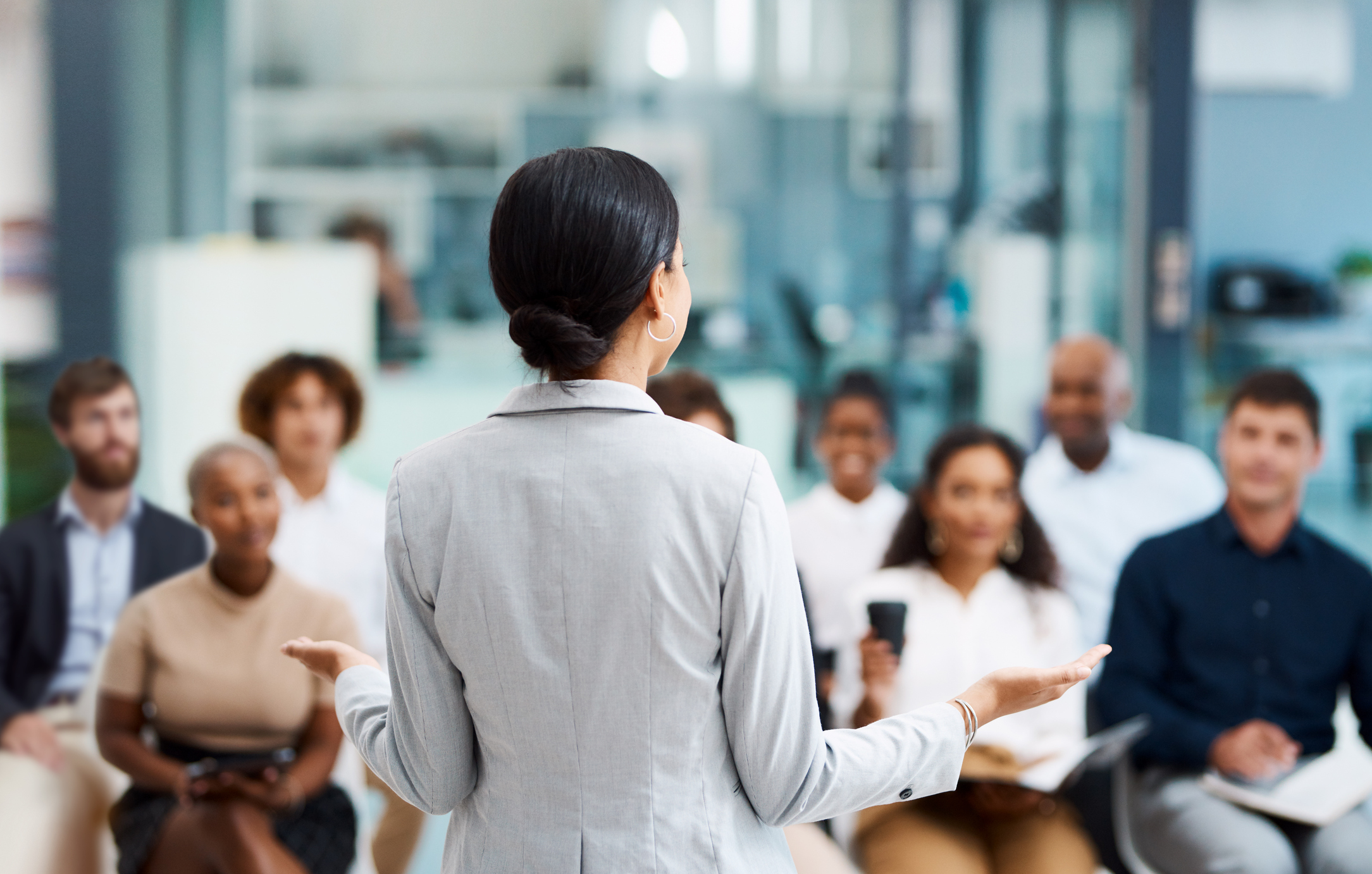Presenter standing in front of a seated audience
