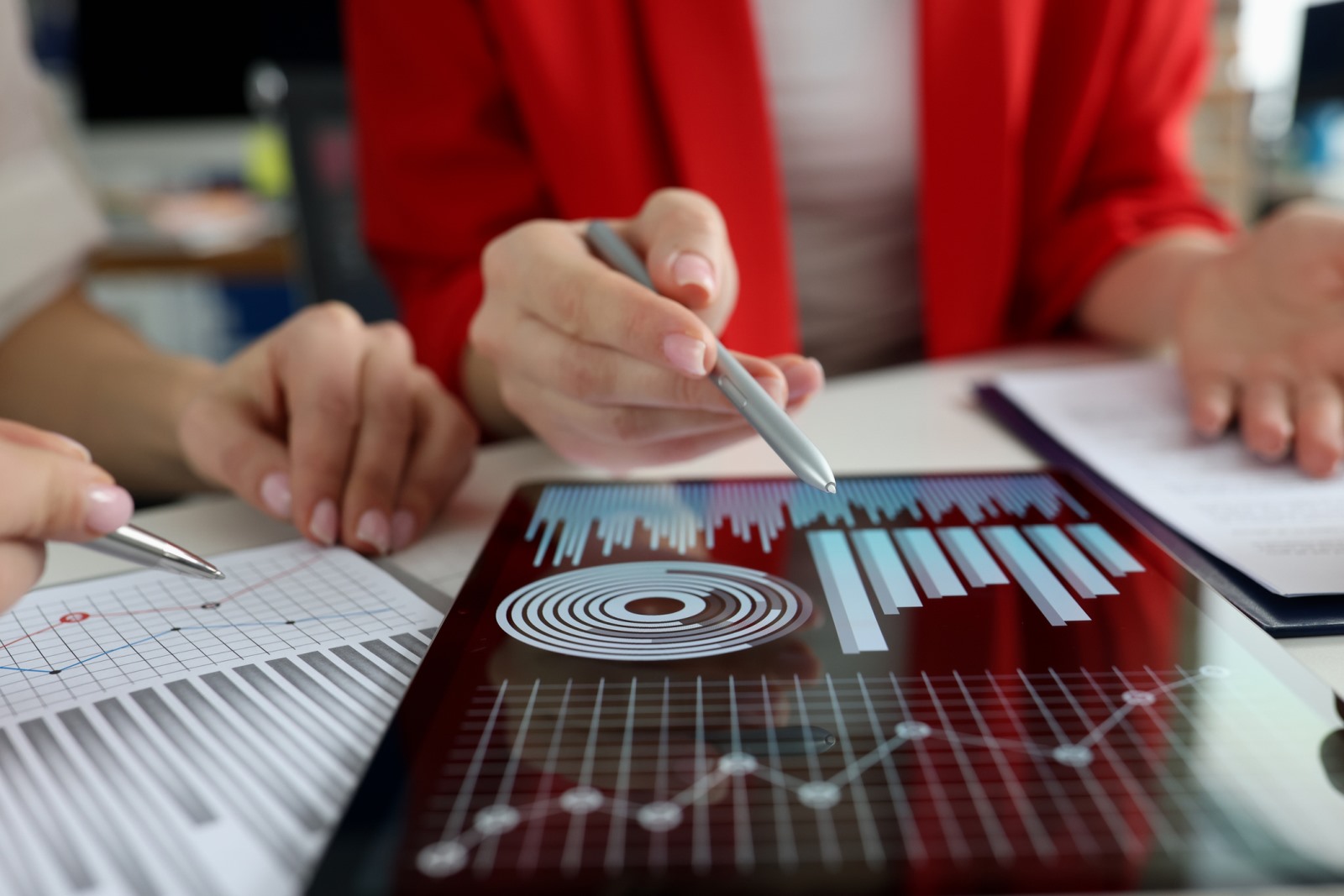 Investment professionals reviewing financial data and charts