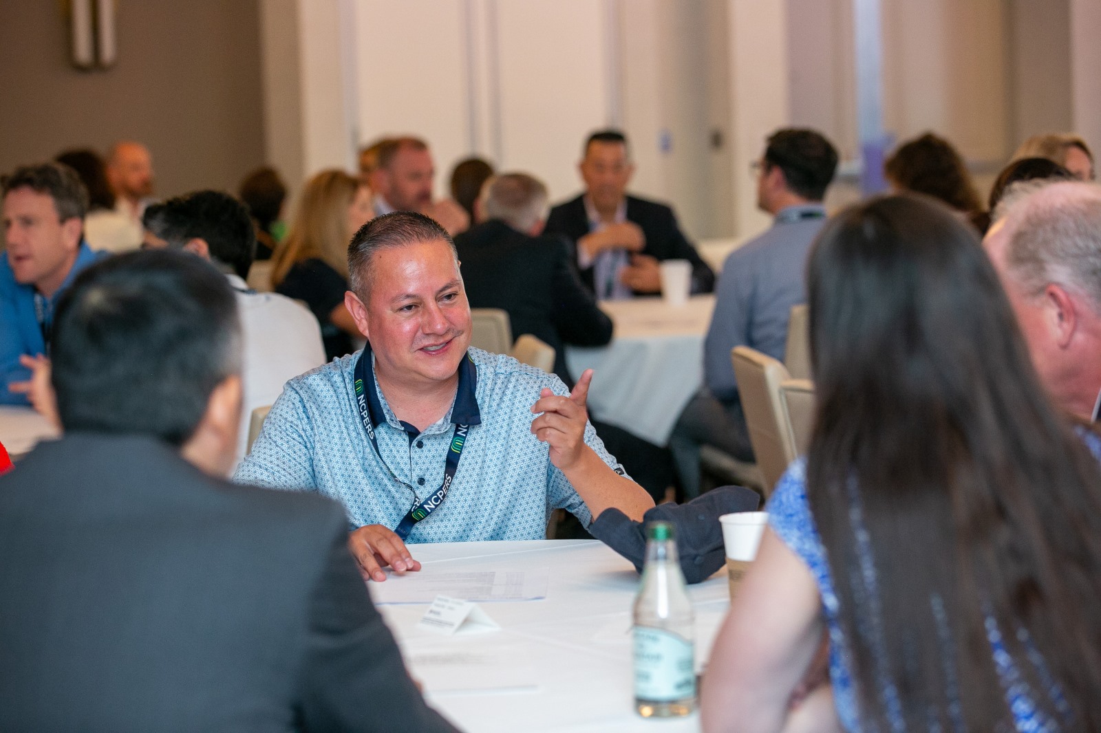 Attendees connecting at a round table during a breakout session