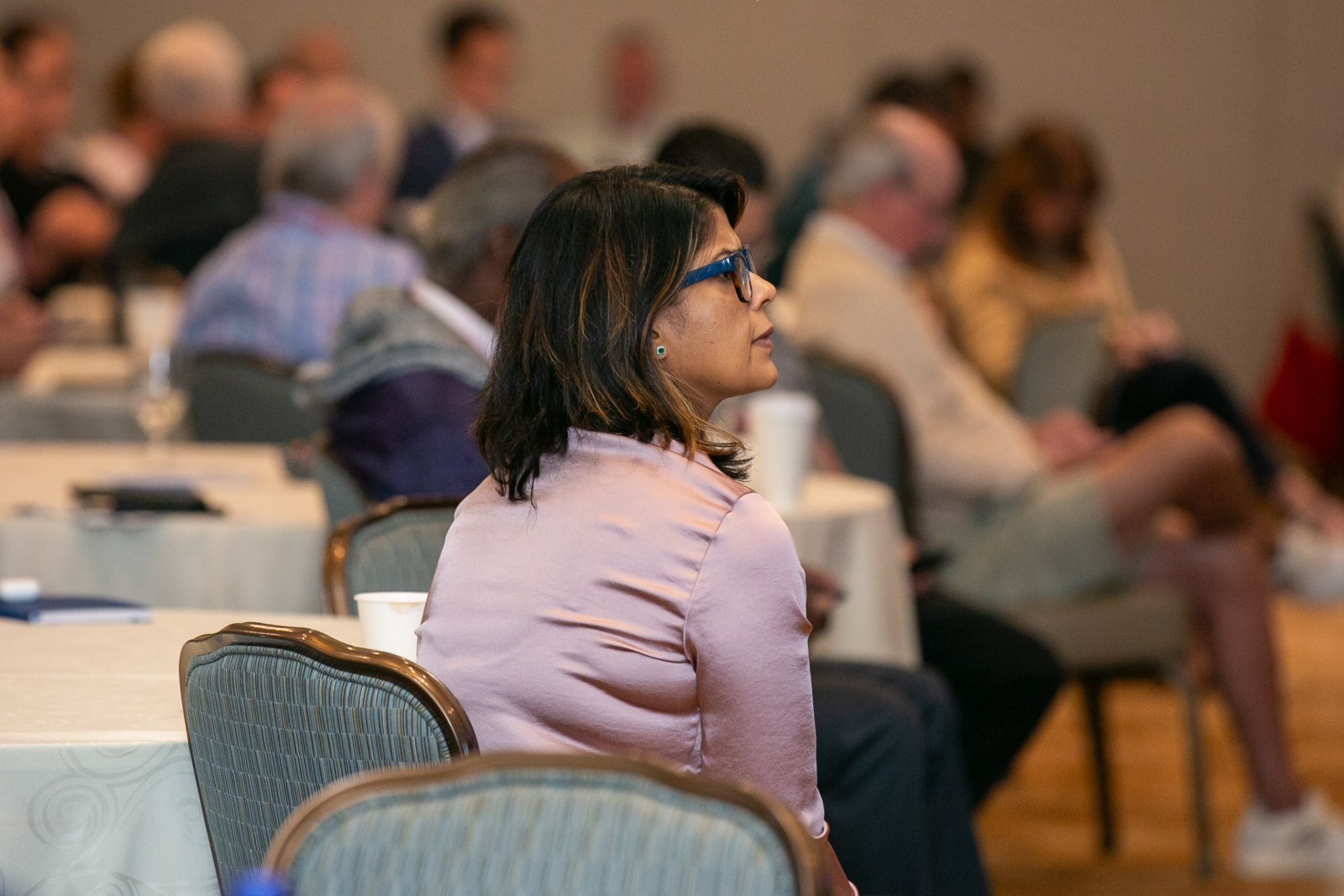 An audience member watching a presentation