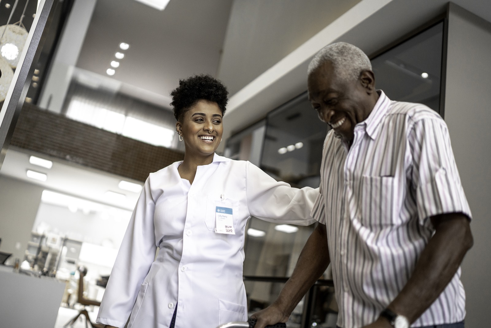 Retiree is supported by nurse in healthcare setting