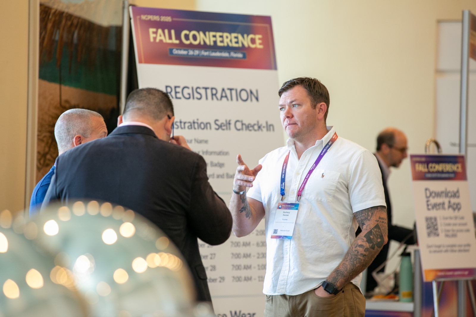 Attendees network in front of signage at NCPERS Conference