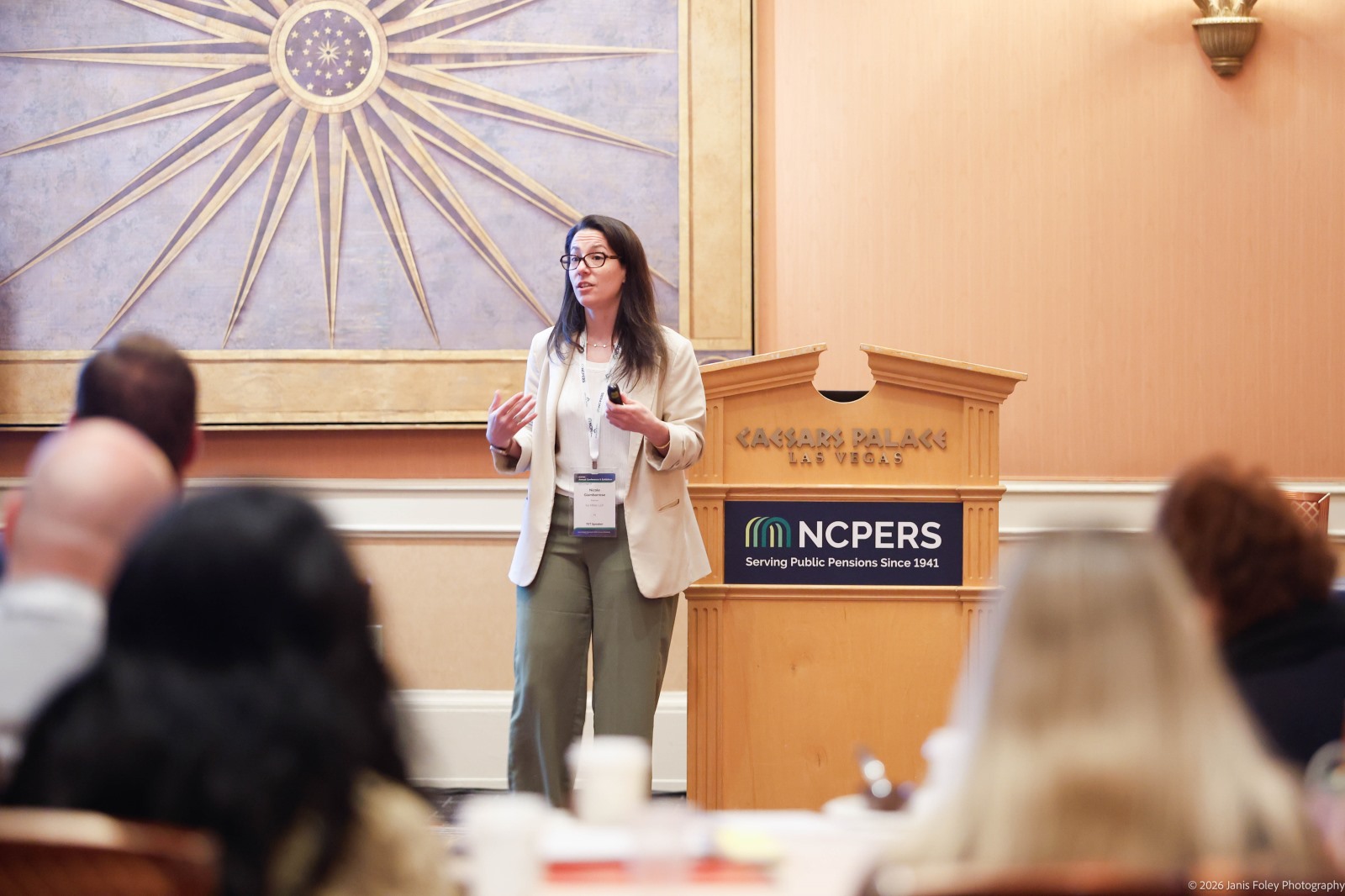 A presenter standing in front of a podium reading "NCPERS University"