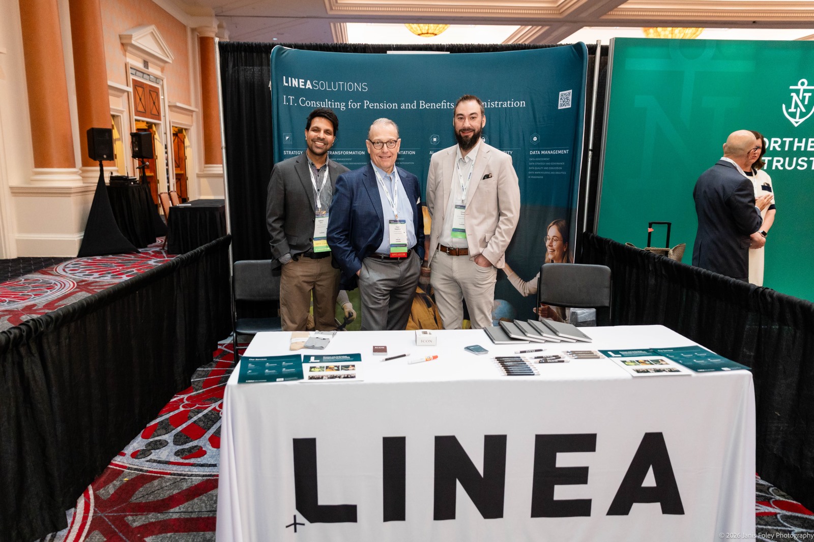 Portrait of three exhibitors from Linea in the exhibit hall