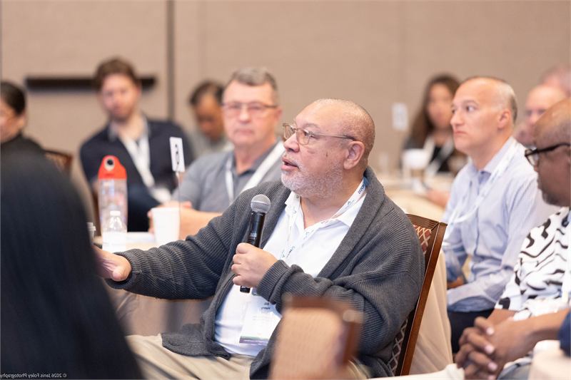 Attendee asks a question holding a microphone