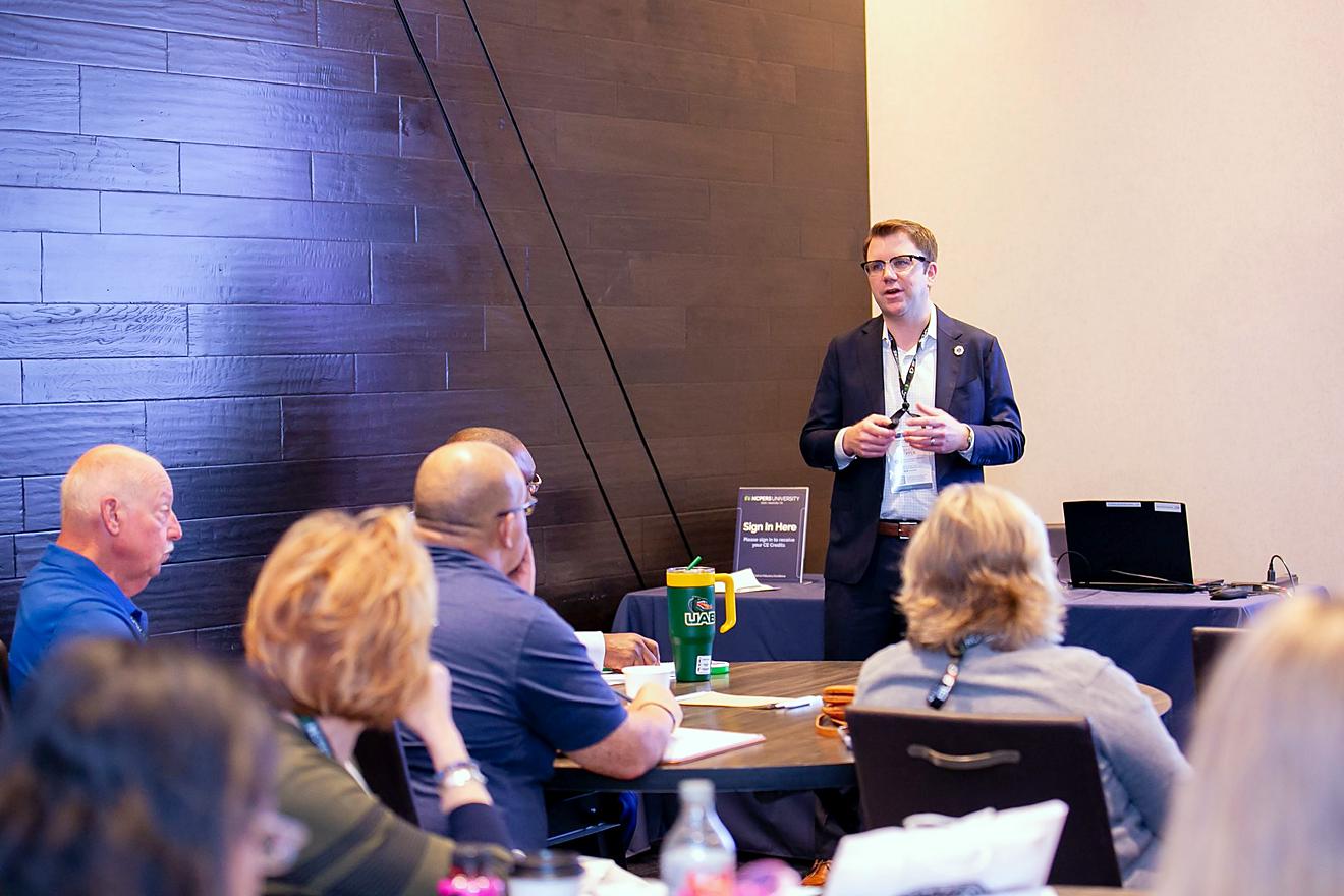 Presenter speaking in front of a crowd