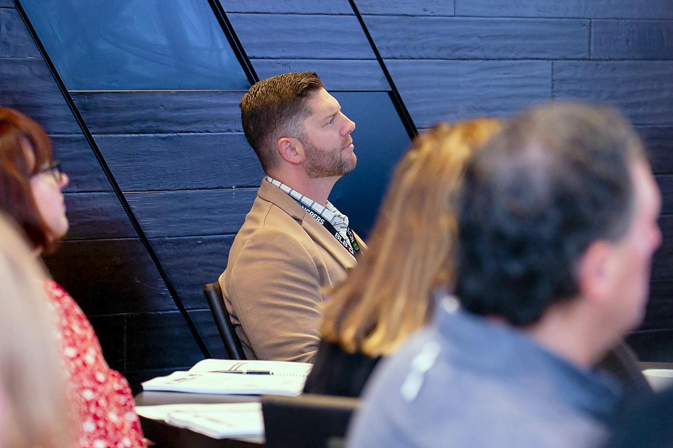 Attendees sitting in the audience watching a presentation