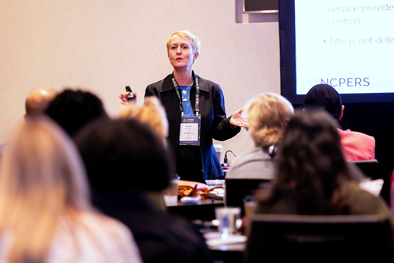 Speaker giving a presentation in front of the audience