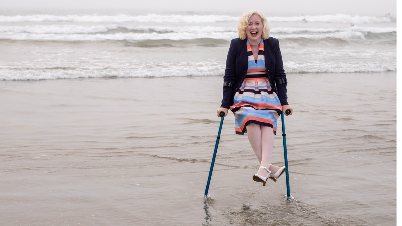 Amy balancing on her crutches in Moro Bay