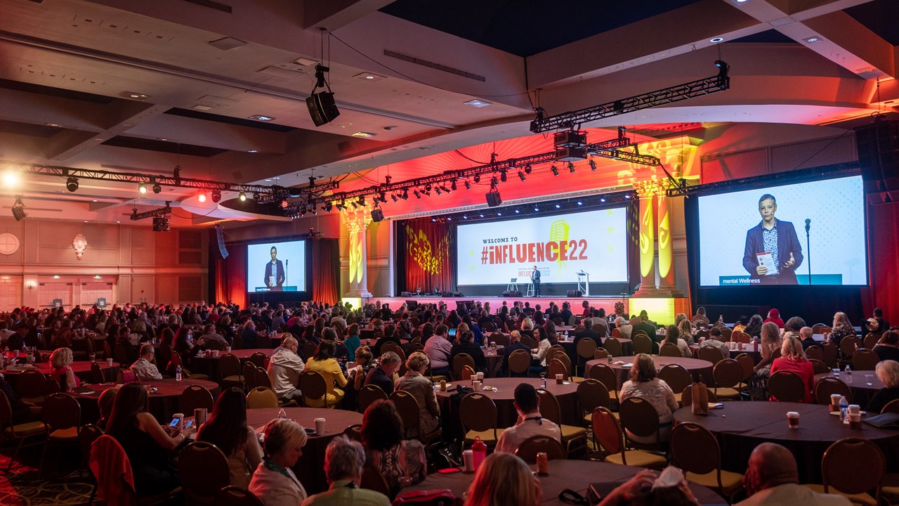 Amy Climer presenting to a large audience