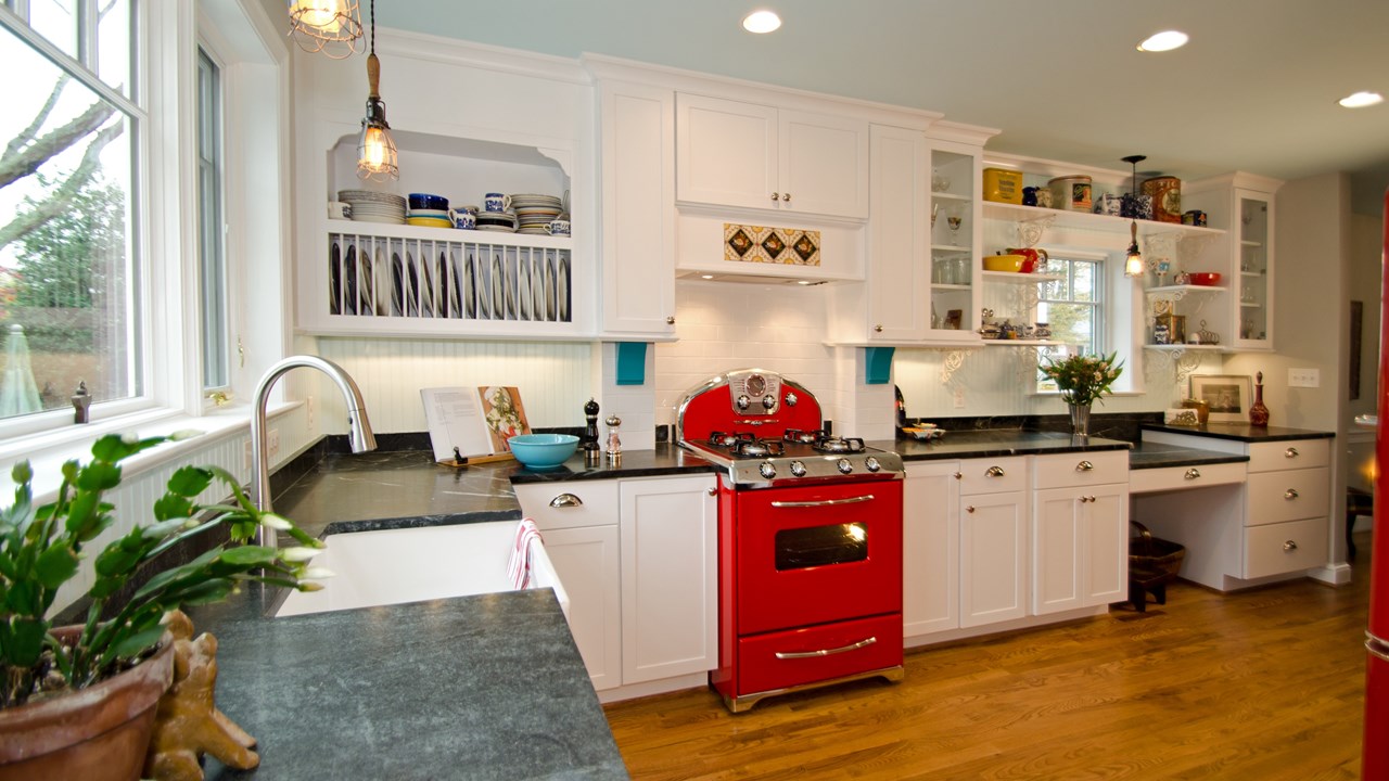 White kitchen with red retro appliances by Merrick Design and Build