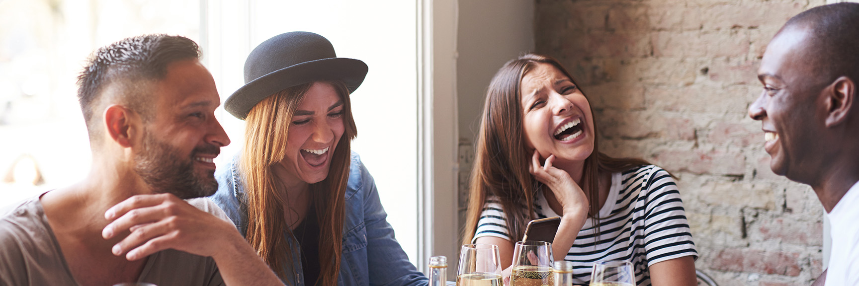 A group of people dining together and laughing