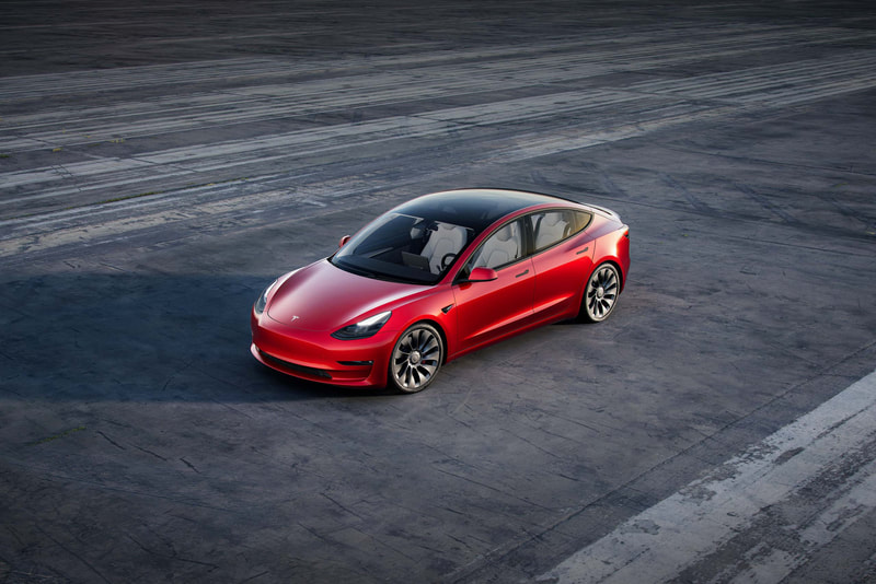 Red Tesla parked 