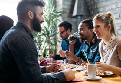 Friends gather at a restaurant dining table