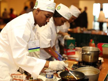 A high school chef prepares a dish at the MPSI competition