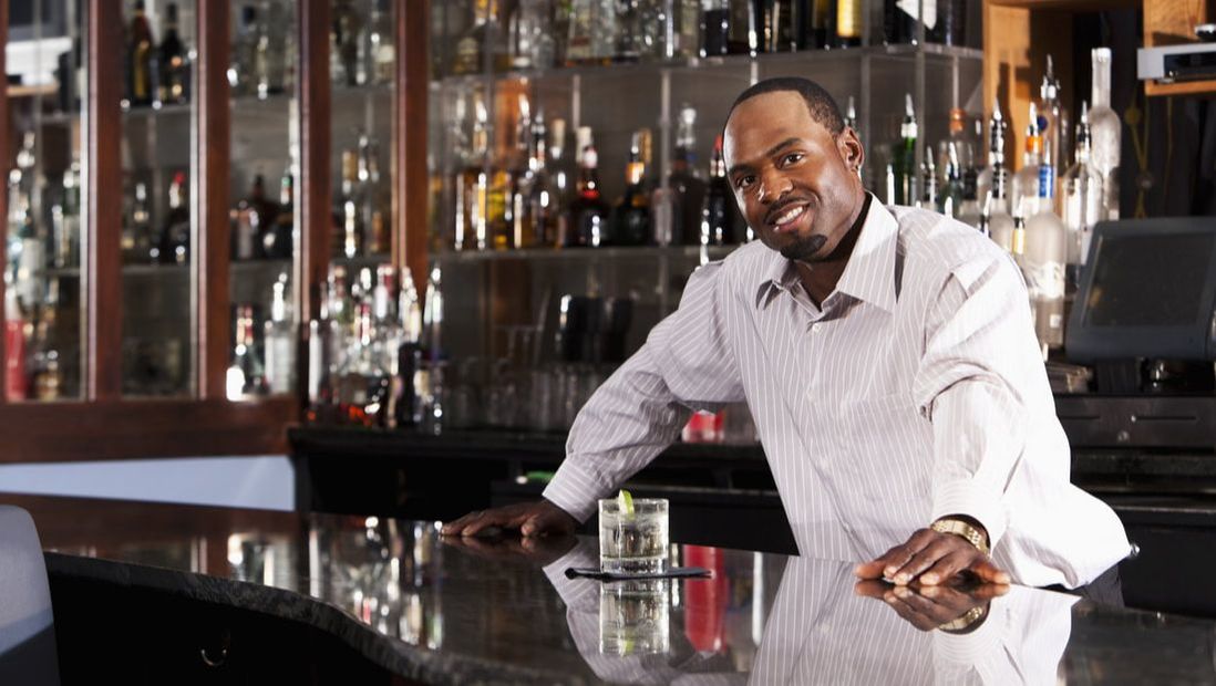 Bartender with cocktail at a bar