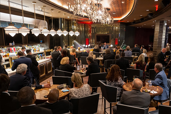 VIP members in a fancy bar setting, listening to live music