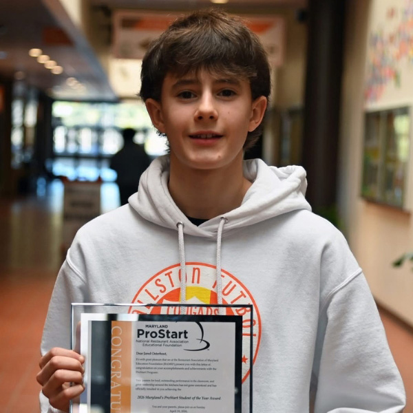 Jared Osterhout holding his award in a frame